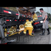photograph of car under trailer