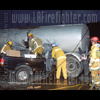 photograph of pickup truck under hot asphalt tanker