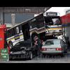 photograph of bus ontop of cars