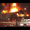 L.A. City firefighters set up ladder pipes for an attack.