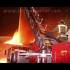 photograph of fireman next to ladder pipe.