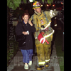 photograph of firefighter directing citizen to safety